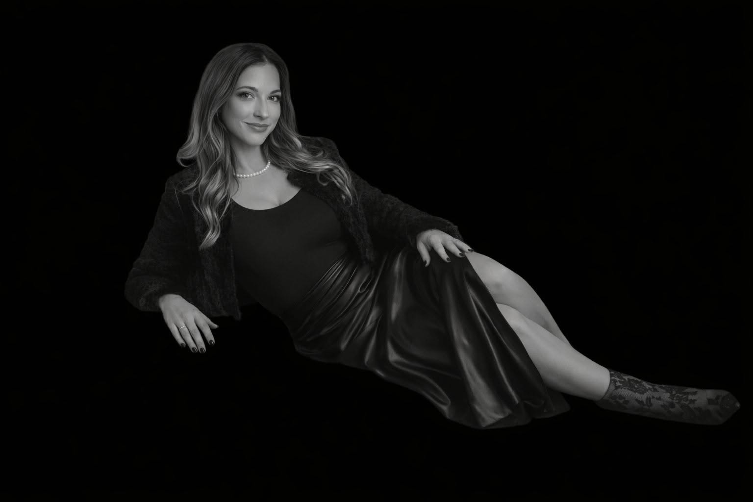Jessica Ann, narrative architect and creative strategist, seated in a black-and-white portrait